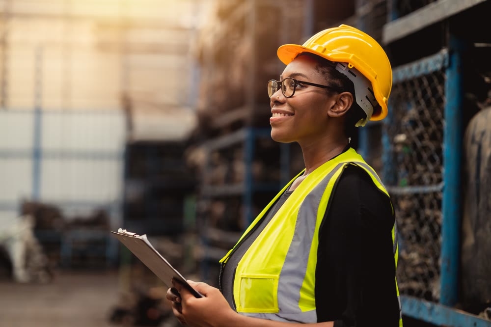 Manufacturing technician in a hard hat and safety vest